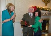 25 November 2015; Team Ireland's Ashleigh O'Hagan, a member of Lisnagry Special Olympics Club, from Limerick City, makes a presentation to President Michael D. Higgins and wife Sabina on behalf of Special Olympics Ireland in Aras an Uachtarain as the Special Olympics World Summer Games are honoured. Aras an Uachtarain, Phoenix Park, Dublin. Picture credit: Ray McManus / SPORTSFILE
