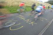 25 August 2009; Cyclists pass over a good will message as they pursue seven times winner of the Tour de France Lance Armstrong during a ride in the Phoenix Park, Dublin. Picture credit: Stephen McCarthy / SPORTSFILE