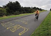 25 August 2009; A cyclist passes a 'Lance Thank You' sign after Lance Armstrong led a cycle in the Phoenix Park, Dublin. Picture credit: Brian Lawless  / SPORTSFILE