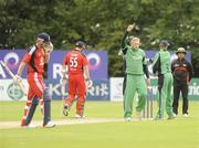 27 August 2009 ; Ireland's Regan West, middle, is congratulated by Ireland Captain, William Porterfield, after taking the wicket of  England Captain Paul Collingwoo, left. One Day Cricket International, Ireland v England, Stormont, Belfast, Co. Antrim. Picture credit: Oliver McVeigh / SPORTSFILE