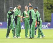 27 August 2009; Kevin O'Brien, Ireland, seond from right, is congratulated by Niall O'Brien, Trent Johnston, Alex Cusack, bowler, and William Porterfield, after catching the wicket of Adil Rashid, England. One Day Cricket International, Ireland v England, Stormont, Belfast, Co. Antrim. Picture credit: Oliver McVeigh / SPORTSFILE