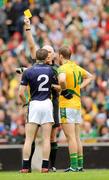 30 August 2009; Brian Farrell, Meath, and Marc O Se, Kerry, are both shown a yellow card by referee Gearoid O  Conamha during the first half. GAA All-Ireland Senior Football Championship Semi-Final, Kerry v Meath, Croke Park, Dublin. Picture credit: Ray McManus / SPORTSFILE
