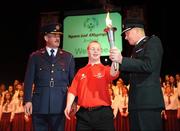 10 September 2009; Special Olympics athlete John Paul Doyle, from Kerry Stars Special Olympics Club, arrives with the Special Olympics torch accompanied by Deputy Commissioner of An Garda Siochana Nacie Rice, left, and Supt Peter Loughins of the PSNI, at the launch of the 2010 Special Olympics Ireland Games. The Games will take place in Limerick from 9-13th June. Nineteen hundred athletes will participate in 4 days of sporting competition in venues throughout Limerick. The Games will be supported by a team of 3,500 volunteers who will be recruited over the coming months. Concert Hall, Limerick University, Limerick. Picture Credit: Brendan Moran / SPORTSFILE