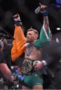 12 December 2015; Conor McGregor has the featherweight belt put on by UFC President Dana White after defeating Jose Aldo in round one to win the UFC Featherweight Championship title. UFC 194: Jose Aldo v Conor McGregor, MGM Grand Garden Arena, Las Vegas, USA. Picture credit: Ramsey Cardy / SPORTSFILE