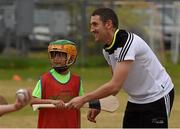 12 December 2015; Seven year old Finn Harte with Kerry's John Griffin during a Celtic Cowboys coaching session. All-Star Tour 2015, sponsored by Opel. McEachern Field, Austin, Texas, USA. Picture credit: Ray McManus / SPORTSFILE
