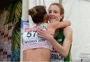 13 December 2015; Ireland's Fionnuala McCormack hugs Portugal's Carla Salomé Rocha, who finished 21st, after finishing fourth in the Senior Women's event. SPAR European Cross Country Championships Hyeres 2015. Paray Le Monial, France. Picture credit: Cody Glenn / SPORTSFILE