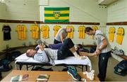 27 June 2015; Neil Gallagher, Donegal, reading the match programme as he gets some strapping done  in the team changing room before the game. Ulster GAA Football Senior Championship, Semi-Final, Derry v Donegal. St Tiernach's Park, Clones, Co. Monaghan. Picture credit: Oliver McVeigh / SPORTSFILE