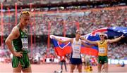 29 August 2015; Rob Heffernan of Ireland after finishing 5th in the final of the Men's 50km Race Walk while gold medal winner Matej Toth of Slovakia and silver medal winner Jared Tallent of Australia celebrate in the background. IAAF World Athletics Championships Beijing 2015 - Day 8, National Stadium, Beijing, China. Picture credit: Stephen McCarthy / SPORTSFILE