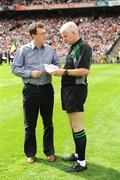23 August 2009; Dominic McCaughey, Tyrone County Board Secretary, hands the team sheet to referee John Bannon before the game. GAA Football All-Ireland Senior Championship Semi-Final, Tyrone v Cork, Croke Park, Dublin. Picture credit: Ray McManus / SPORTSFILE