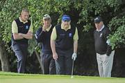 17 September 2009; Tony Slevin, left, Loughrea Golf Club, Co. Galway, and his playing partner John Creavan, 2nd from right, and their caddies Des Egan and Peter Murphi, right, review the situation on the 4th green during the Bulmers Pierce Purcell Shield Semi-Final. Bulmers Cups and Shields Finals 2009, Tullamore Golf Club, Brookfield, Tullamore, Co. Offaly. Picture credit: Ray McManus / SPORTSFILE