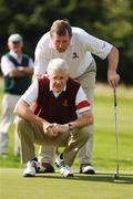 17 September 2009; Andy Montgomery, Malone Golf Club, leans over his caddy Rollo McClure, who is the GUI Hon Treasurer, to view a line on the 17th during the Bulmers Junior Cup Final. Bulmers Cups and Shields Finals 2009, Tullamore Golf Club, Brookfield, Tullamore, Co. Offaly. Picture credit: Ray McManus / SPORTSFILE