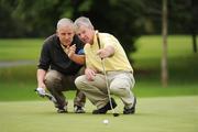 17 September 2009; Eddie Cogan, Douglas Golf Club, Co. Cork, and his caddy Karl Bornemann line up a putt on the 18th during the Bulmers Pierce Purcell Shield Semi-Final. Bulmers Cups and Shields Finals 2009, Tullamore Golf Club, Brookfield, Tullamore, Co. Offaly. Picture credit: Ray McManus / SPORTSFILE