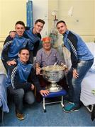 25 December 2015; Dublin footballers Cormac Costello, Brian Fenton, Eoin Culligan and captain Stephen Cluxton with Denis Byrne from Fairview, Dublin, when they and the Sam Maguire visited patients of Beaumount Hospital on Christmas Day. Mr Byrne won an Intermediate Dublin Championship medal with St Joseph's in 1959. Beaumont Hospital, Beaumont Rd, Dublin.  Picture credit: Ray McManus / SPORTSFILE