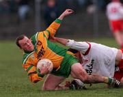 11 February 2001; Adrian Sweeney of Donegal is tackled by Declan McCrossan of Tyrone during the Allianz National Football League Division 1B match between Tyrone and Donegal at Healy Park in Omagh, Tyrone. Photo by Damien Eagers/Sportsfile
