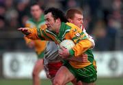 11 February 2001; Damien Diver of Donegal is tackled by Owen Mulligan of Tyrone during the Allianz National Football League Division 1B match between Tyrone and Donegal at Healy Park in Omagh, Tyrone. Photo by Damien Eagers/Sportsfile