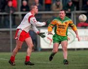11 February 2001; Sean Teague of Tyrone gets his handpass away despite the attentions of Adrian Sweeney of Donegal during the Allianz National Football League Division 1B match between Tyrone and Donegal at Healy Park in Omagh, Tyrone. Photo by Damien Eagers/Sportsfile