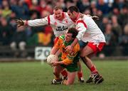 11 February 2001; Tony Boyle of Donegal is tackled by Chris Lawn, left, and Declan McCrossan of Tyrone during the Allianz National Football League Division 1B match between Tyrone and Donegal at Healy Park in Omagh, Tyrone. Photo by Damien Eagers/Sportsfile