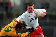 11 February 2001; Cormac McAnallen of Tyrone is tackled by Barry Monaghan of Donegal during the Allianz National Football League Division 1B match between Tyrone and Donegal at Healy Park in Omagh, Tyrone. Photo by Damien Eagers/Sportsfile