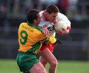 11 February 2001; Cormac McAnallen of Tyrone is tackled by Barry Monaghan of Donegal during the Allianz National Football League Division 1B match between Tyrone and Donegal at Healy Park in Omagh, Tyrone. Photo by Damien Eagers/Sportsfile