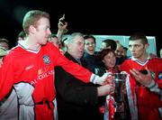 12 February 2001; Stephen McGuinness left, and captain Trevor Croly of St Patrick's Athletic are presented with the cup by Chairman of eircom League Michael Hyland and Adrienne O'Regan, Head of Sponsorship in eircom, after the Eircom League Cup Final 2nd Leg match between UCD and St Patrick's Athletic at Belfield Park in Dublin. Photo by David Maher/Sportsfile