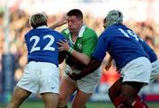 17 February 2001; Emmet Byrne of Ireland is tackled by Christophe Dominici and Serge Betsen, right, of France during the Lloyds TSB Six Nations Rugby Championship match between Ireland and France at Lansdowne Road in Dublin. Photo by Brendan Moran/Sportsfile