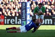 17 February 2001; Rob Henderson of Ireland is tackled by Richard Dourthe of France during the Lloyds TSB Six Nations Rugby Championship match between Ireland and France at Lansdowne Road in Dublin. Photo by Brendan Moran/Sportsfile