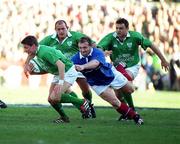 17 February 2001; Ronan O'Gara of Ireland is tackled by Olivier Magne of France during the Lloyds TSB Six Nations Rugby Championship match between Ireland and France at Lansdowne Road in Dublin. Photo by Brendan Moran/Sportsfile