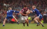 18 February 2001; Enda Lavelle of Crossmolina Deel Rovers gets through the tackle of Bellaghy's Gareth Doherty, left, and Peter Diamond of Bellaghy Wolfe Tones during the AIB All-Ireland Senior Club Football Championship Semi-Final match between Crossmolina Deel Rovers v Bellaghy Wolfe Tones at Brewster Park in Enniskillen, Fermanagh. Photo by Ray McManus/Sportsfile
