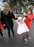 28 December 2015; Racegoers Aideen Ryan, left, and her sister Clara McCarthy, lift Clara's daughter Lily McCarthy, age 3, all from Rathwire, Co. Westmeath at the races. Leopardstown Christmas Racing Festival, Leopardstown Racecourse, Dublin. Picture credit: Cody Glenn / SPORTSFILE