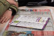 28 December 2015; A racegoer reads a race card and a newspaper during The Winning Line at the Leopardstown Christmas Racing Festival, Leopardstown Racecourse, Dublin. Picture Credit: Ray McManus / SPORTSFILE