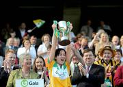 13 September 2009; Offaly captain Marion Crean lifts the New Ireland Cup in the company of An Taoiseach Brian Cowen TD and President of the Camogie Association Joan O'Flynn. Gala All-Ireland Junior Camogie Championship Final, Offaly v Waterford, Croke Park, Dublin. Picture credit: Brian Lawless / SPORTSFILE