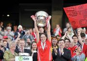 13 September 2009; Cork captain Amanda O'Regan lifts the cup in the company of An Taoiseach Brian Cowen TD and President of the Camogie Association Joan O'Flynn. Gala All-Ireland Senior Camogie Championship Final, Cork v Kilkenny, Croke Park, Dublin. Picture credit: Brian Lawless / SPORTSFILE