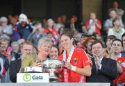 13 September 2009; Cork captain Amanda O'Regan is presented with the cup by President of the Camogie Association Joan O'Flynn in the company of An Taoiseach Brian Cowen TD. Gala All-Ireland Senior Camogie Championship Final, Cork v Kilkenny, Croke Park, Dublin. Picture credit: Brian Lawless / SPORTSFILE