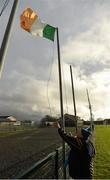 3 January 2016; Crossmaglen Rangers GAA Club member Larry Gavin raises the tricolour ahead of the game. Bank of Ireland Dr. McKenna Cup, Group C, Round 1, Armagh v Cavan. St Oliver Plunkett Park, Crossmaglen, Co. Armagh. Picture credit: Stephen McCarthy / SPORTSFILE