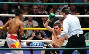 26 September 2009; Bernard Dunne falls to the canvas for the second time during the third round of his WBA World Super Bantamweight title fight, with Poonsawat Kratingdaenggym. Hunky Dorys World Title Fight Night, Bernard Dunne v Poonsawat Kratingdaenggym, The O2, Dublin. Picture credit: Stephen McCarthy / SPORTSFILE