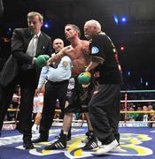 26 September 2009; Bernard Dunne is helped back to his corner after being defeated by Poonsawat Kratingdaenggym on the three knockdown rule after 2 minutes 57 seconds of the third round of their WBA World Super Bantamweight title fight. Hunkys Dorys World Title Fight Night, Bernard Dunne v Poonsawat Kratingdaenggym, The O2, Dublin. Picture credit: David Maher / SPORTSFILE