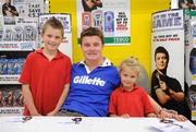 24 September 2009; Adam Smith, age 9, and his sister Aliesha, age 5, from Milltown, at a Gillette / Tesco In-Store Signing with Brian O'Driscoll, as fans get a close shave with grand slam hero: Gillette Ambassador Brian O’Driscoll takes part in a Tesco in-store signing much to the delight of the large crowd that packed the Dundrum Town Centre store. The in-store signing is part of a Gillette / Tesco promotion which is offering up to 50% off selected Gillette items including the new Gillette Gamer Razor. The rugby legend will now turn his attention to the new rugby season where he attempts to defend the RBS 6 Nations with Ireland and the Heineken Cup European title with Leinster. Gillette / Tesco In-Store Signing with Brian O'Driscoll, Tesco, Dundrum, Co. Dublin. Picture credit: Brendan Moran / SPORTSFILE  *** Local Caption ***