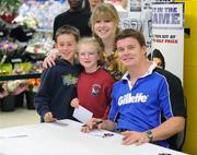 24 September 2009; Oisin, age 9, Blathin, age 7, and Kerry Murphy, all from Greystones at a Gillette / Tesco In-Store Signing with Brian O'Driscoll, as fans get a close shave with grand slam hero: Gillette Ambassador Brian O’Driscoll takes part in a Tesco in-store signing much to the delight of the large crowd that packed the Dundrum Town Centre store. The in-store signing is part of a Gillette / Tesco promotion which is offering up to 50% off selected Gillette items including the new Gillette Gamer Razor. The rugby legend will now turn his attention to the new rugby season where he attempts to defend the RBS 6 Nations with Ireland and the Heineken Cup European title with Leinster. Gillette / Tesco In-Store Signing with Brian O'Driscoll, Tesco, Dundrum, Co. Dublin. Picture credit: Brendan Moran / SPORTSFILE  *** Local Caption ***