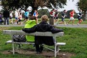 26 September 2009; A couple relax on a park bench as the field race past during the Lifestyle Sports - adidas Dublin Half Marathon. Phoenix Park, Dublin. Photo by Sportsfile