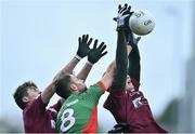 3 January 2016; Jason Gibbons, Mayo, in action against Michael Daly, left, and Peter Cooke, NUIG. FBD Connacht League, Section A, Mayo v NUIG. Elverys MacHale Park, Castlebar, Co. Mayo. Picture credit: David Maher / SPORTSFILE