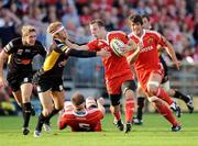 27 September 2009; Tomas O'Leary, Munster, is tackled by Martyn Thomas, Newport Gwent Dragons. Celtic League, Munster v Newport Gwent Dragons, Musgrave Park, Cork. Picture credit: Matt Browne / SPORTSFILE