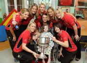 28 September 2009; Slaney McKenna, from Monaghan, with the Brendan Martin Cup and players, clockwise from left, captain Mary O'Connor, Carmel McCarthy, Juliet Murphy, Nollaig Cleary, Róisin O'Sullivan, Amy O'Shea, Deirdre O'Reilly and Norita Kelly during a visit by the winning All-Ireland Cork Ladies Football team to Our Lady's Hospital for Sick Chidren in Crumlin. Crumlin, Co. Dublin. Photo by Sportsfile