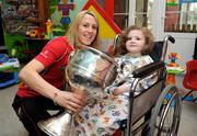 28 September 2009; Slaney McKenna, from Monaghan, with the Brendan Martin Cup and captain Mary O'Connor during a visit by the winning All-Ireland Cork Ladies Football team to Our Lady's Hospital for Sick Chidren in Crumlin. Crumlin, Co. Dublin. Photo by Sportsfile