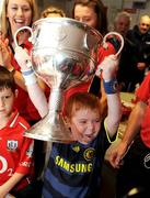 28 September 2009; Oran Tully, from Dublin, lifts the Brendan Martin Cup during a visit by the winning All-Ireland Cork Ladies Football team to Our Lady's Hospital for Sick Chidren in Crumlin. Crumlin, Co. Dublin. Photo by Sportsfile