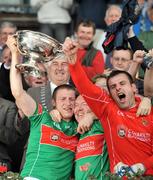 27 September 2009; Timmy Anglin, Clonakilty captain, left, lifts the cup with team-mates Brendan Walsh and Eamon Harte, right. Cork County Senior Football Final, St. Finbarr's v Clonakilty, Páirc Uí Chaoimh, Cork. Picture credit: Brian Lawless / SPORTSFILE