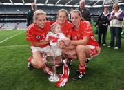 27 September 2009; Cork players, from left, Angela Walsh, Juliet Murphy and Linda Barrett celebrate with Fiachra McGill, age 6 months, grandson of manager Eamon Ryan, and the Brendan Martin cup. TG4 All-Ireland Ladies Football Senior Championship Final, Cork v Dublin, Croke Park, Dublin. Picture credit: Stephen McCarthy / SPORTSFILE