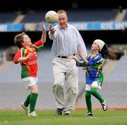 28 September 2009; Declan Moran, Director of Marketing and Business Development, Vhi Healthcare, is tackled by Liam McCormack, age 8, from Bishopstown, Cork, and Sophie Ni Cheidigh, age 7, from the Aran Islands, at the Vhi GAA Cúl Day Out in Croke Park. 288 children from all over the country togged out today in the world-famous Croke Park stadium to attend the Vhi GAA Cúl Day Out. The 288 children were the lucky winners in the competition which was open to 82,500 children who attended a Vhi GAA Cúl Camp during the summer. Vhi GAA Cúl Day Out, Croke Park, Dublin. Picture credit: Brendan Moran / SPORTSFILE