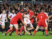 2 October 2009; Ryan Caldwell, Ulster, is tackled by Vernon Cooper, David Lyons and Rhys Thomas, Llanelli Scarlets. Celtic League, Ulster v Llanelli Scarlets, Ravenhill Park, Belfast, Co. Antrim. Picture credit: Oliver McVeigh / SPORTSFILE