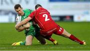 10 January 2016;  Matt Healy, Connacht, is tackled by Ken Owens, Scarlets. Guinness PRO12, Round 12, Scarlets v Connacht, Parc Y Scarlets, Llanelli, Wales. Picture credit: Chris Fairweather / SPORTSFILE