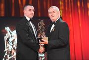 16 October 2009; Eoin Larkin, of Kilkenny, is presented with his GAA Hurling All-Star award by Uachtarán CLG Criostóir Ó Cuana during the 2009 GAA All-Stars Awards, sponsored by Vodafone. Citywest Hotel, Conference, Leisure & Golf Resort, Dublin. Picture credit: Ray McManus / SPORTSFILE